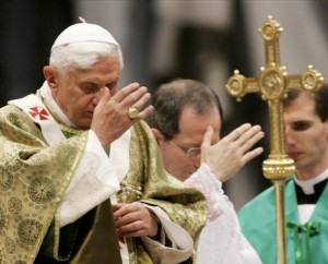 Pope Benedict XVI making the sign of the Cross during mass.